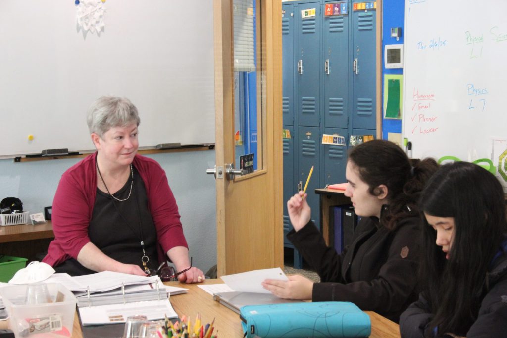 Students and teacher in science class