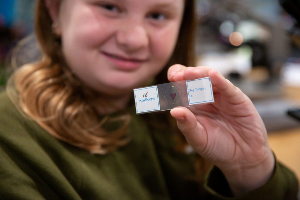 Student holding microscope slide